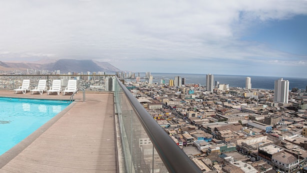 Piscina en la azotea con vista a la ciudad, montañas y la costa.