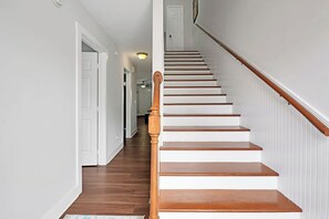A staircase with wooden steps and a wooden handrail, leading to a door at the top. - Shell Of a Ball 3 beds, 2 1/2 bath - 3 blocks from the ocean (Carolina Beach)