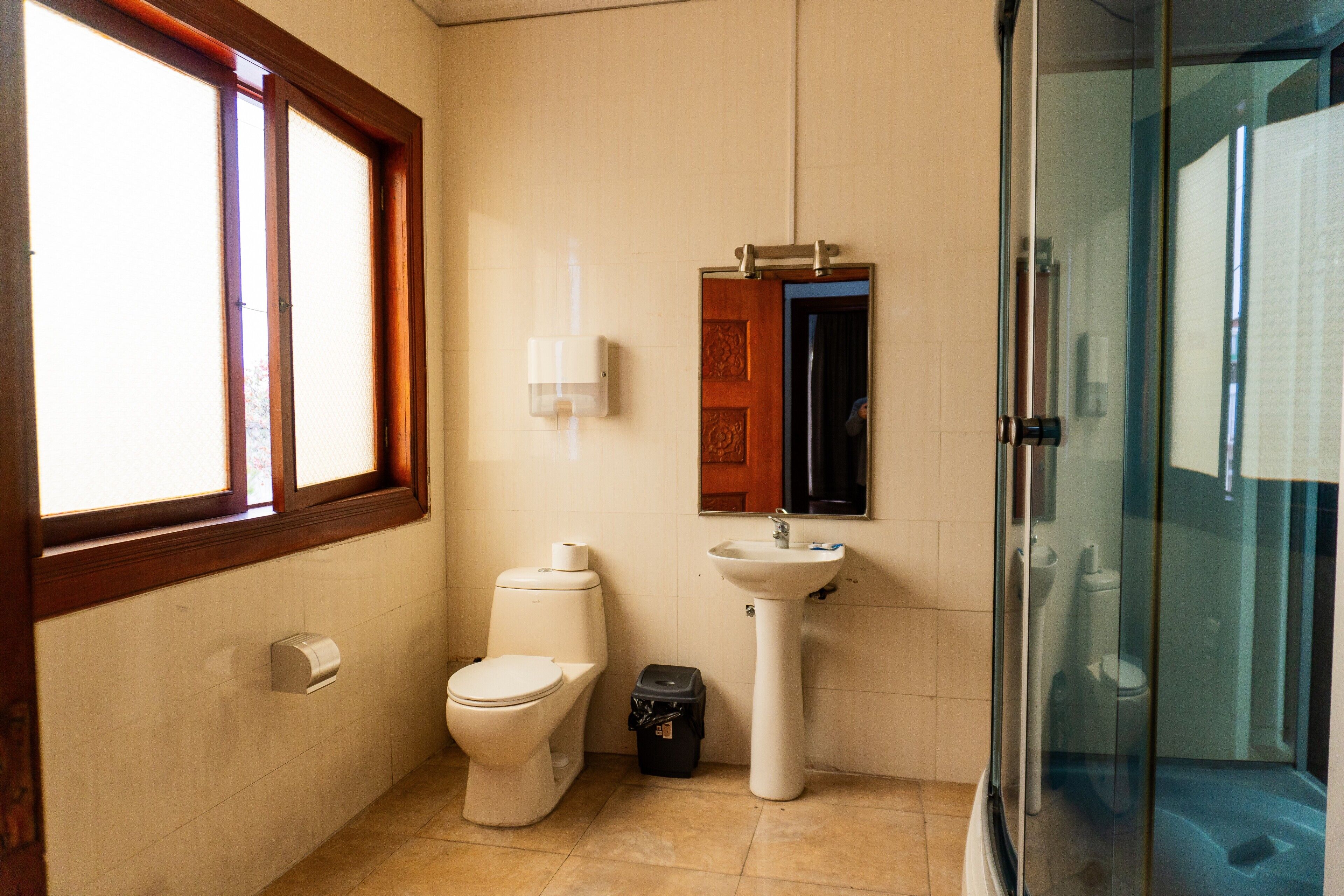 A bathroom with a toilet, sink, and shower.