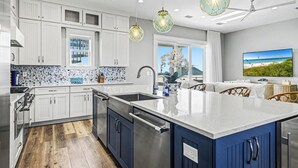 A modern kitchen with white and blue cabinets, a large island, and pendant lighting. - Private Pool Rooftop Deck w/ Panoramic Views It's A Shore Thang (Navarre)