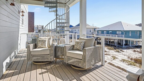 A wooden deck with wicker furniture and a spiral staircase. - Private Pool Rooftop Deck w/ Panoramic Views It's A Shore Thang (Navarre)