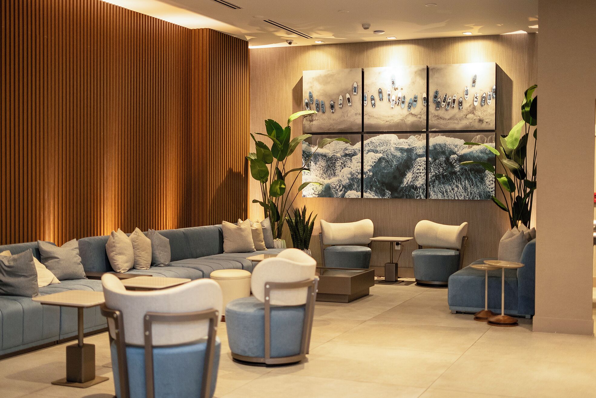 A modern lounge with a sectional sofa, armchairs, and a coffee table.