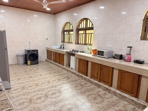 A modern kitchen with a central island, a built-in oven, a microwave, a toaster, and a blender. - The best 5bedroom house with AC in a vibrant yet low key part of Accra. (Accra)