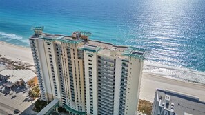 A high-rise hotel with multiple balconies, a rooftop terrace, and a view of the beach and ocean. - Luxury Beachfront 3 Bedroom @ Aqua Resort, Walk to Pier Park and Topgolf & More! (Panama City Beach)
