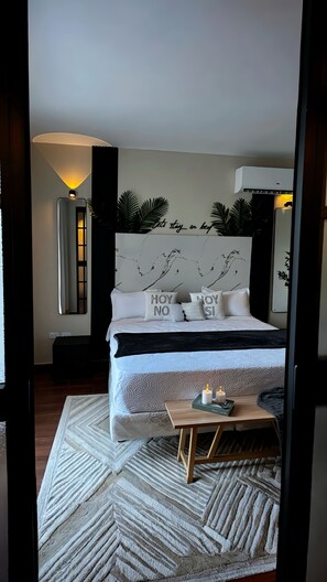 A modern bedroom with a bed, bedside table, and decorative pillows. - Romantic and tropical apartment in the charming city of Puerto Plata (Puerto Plata)