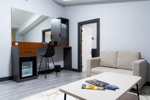 Luxury Suite | Living area | 42-inch Smart TV with digital channels - Rauza Hotel Tashkent (Tashkent)