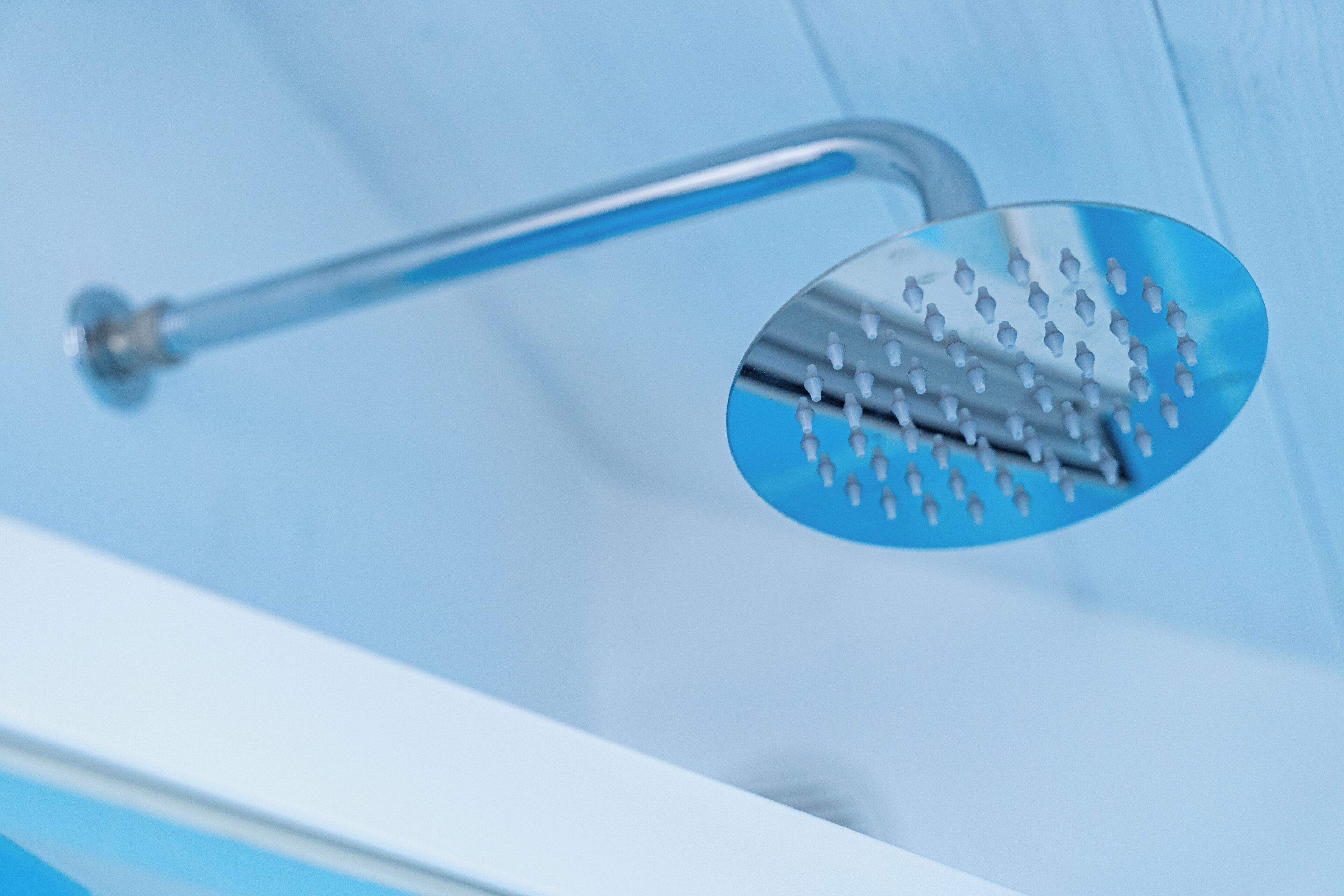 A showerhead with a curved design and a single handle.