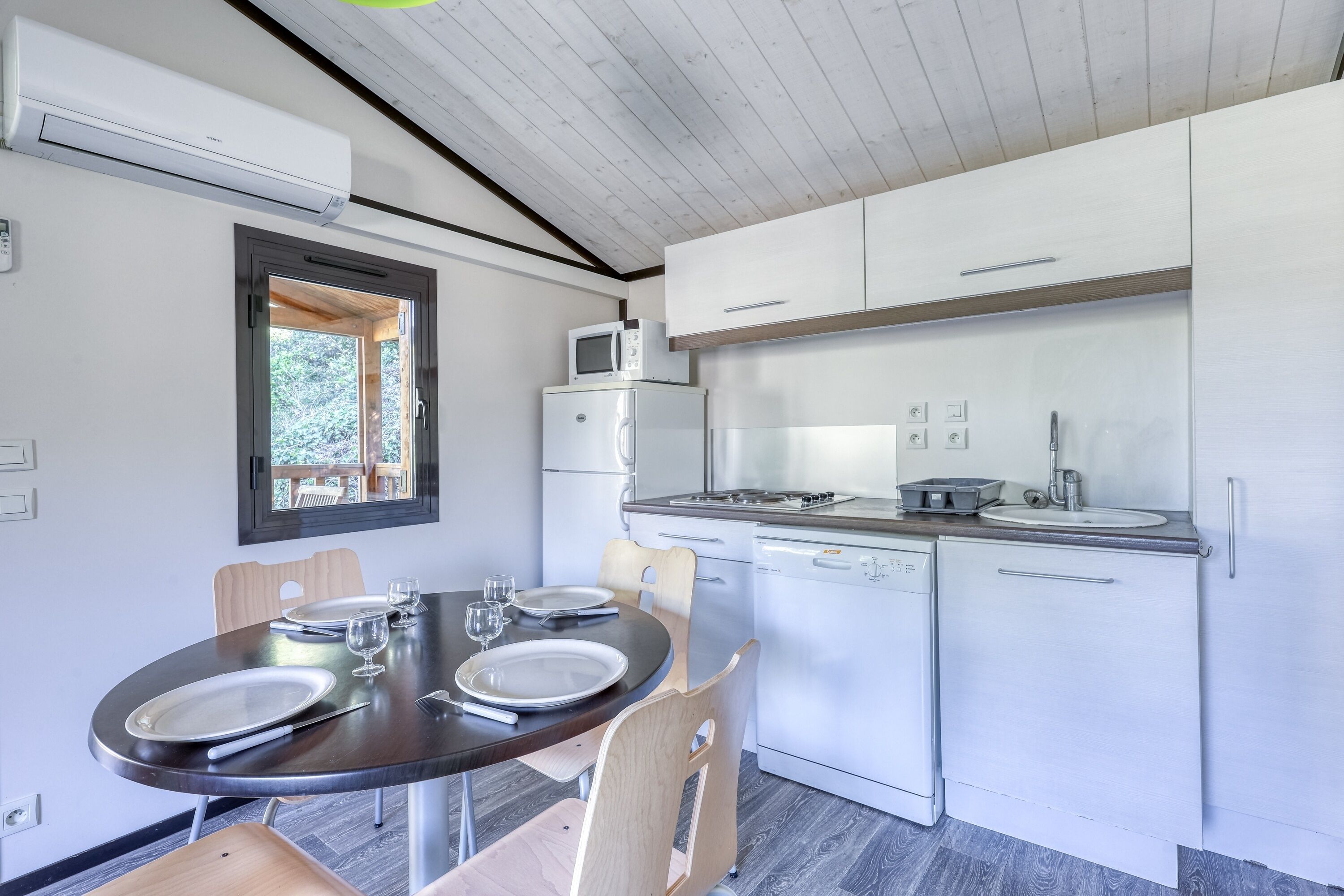 A modern kitchen with white cabinets, a built-in microwave, a stove, and a dishwasher.