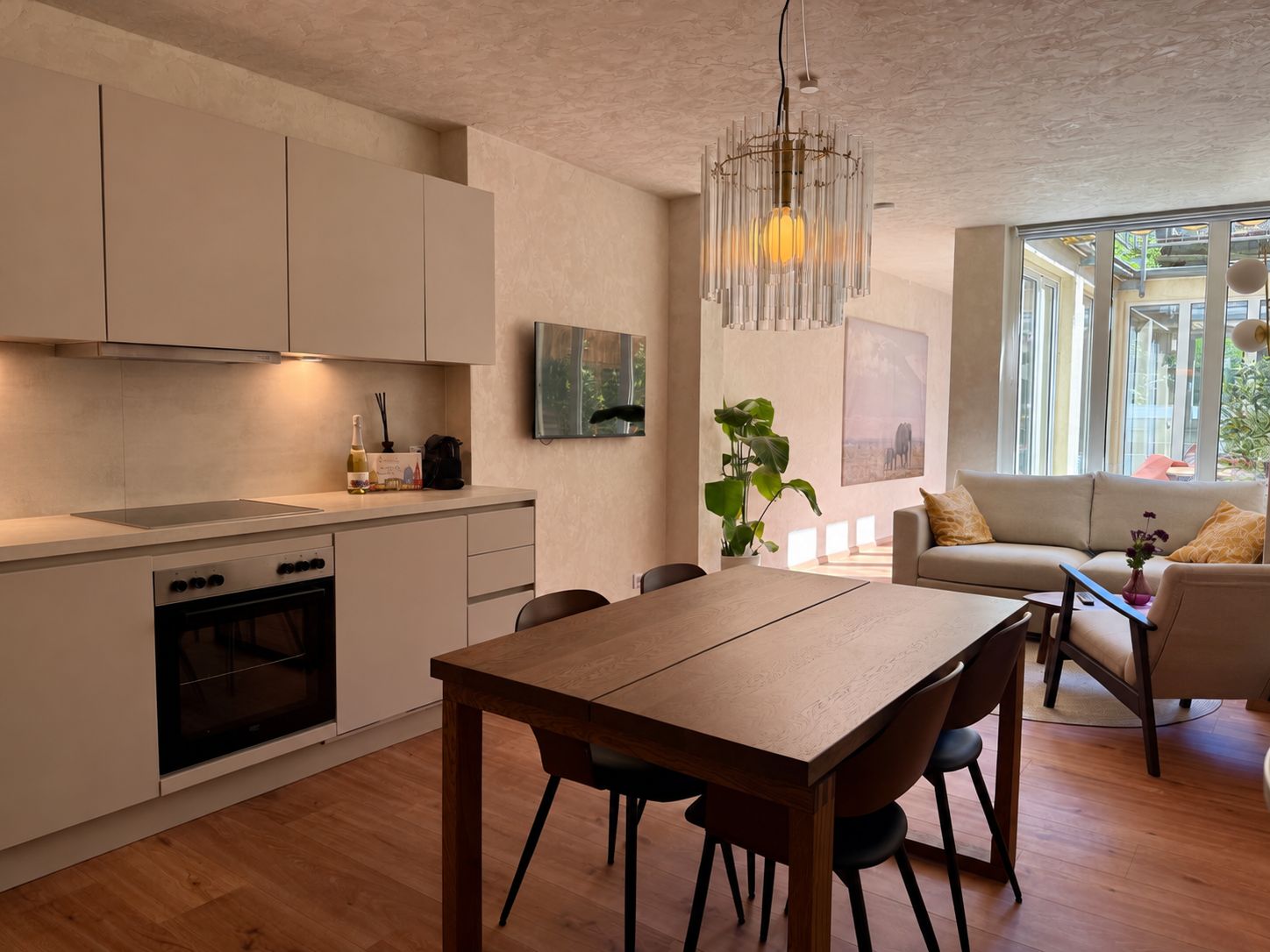 Une cuisine moderne avec un coin repas, une table en bois et des chaises.