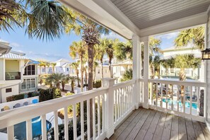 A covered porch with a pool, surrounded by palm trees and other greenery. - Gulf House with Private Pool Just 100 yds to Beach (Rosemary Beach)