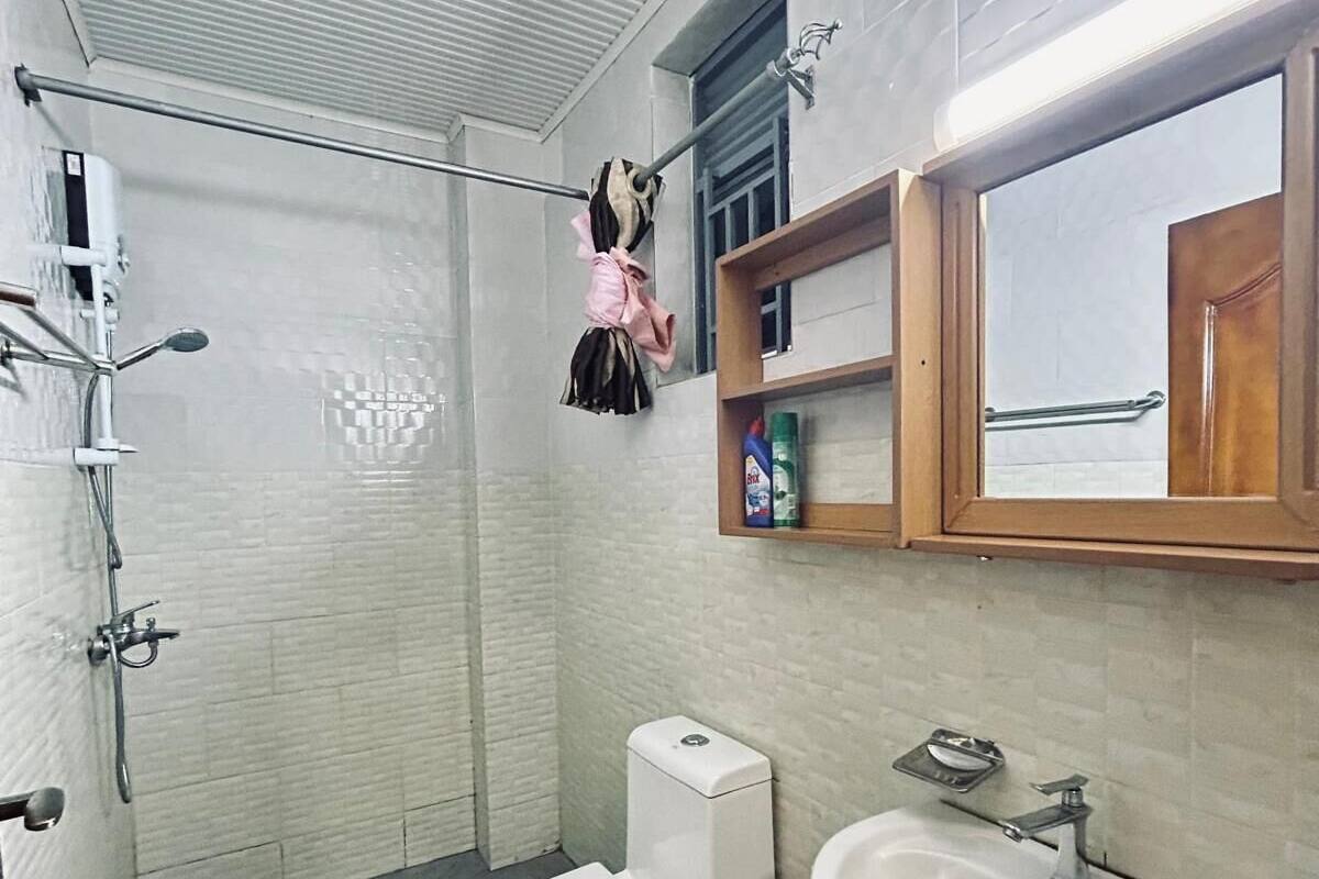 A bathroom with a shower, toilet, and sink.
