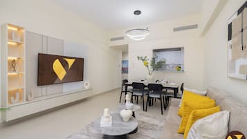 Luxury Apartment, Balcony, City View | Living room | 65-inch Smart TV with cable channels