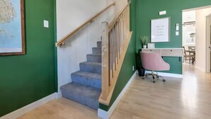 A staircase with wooden handrails leading to a landing. - Entire Pine Ridge - 2 Attached Four Bedroom Condos (Bar Harbor)