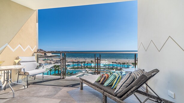 Un balcone con vista sulla spiaggia e sulla piscina.