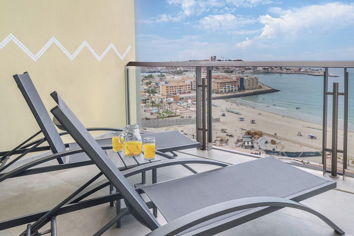 Ein Balkon mit Blick auf Strand und Stadtlandschaft.