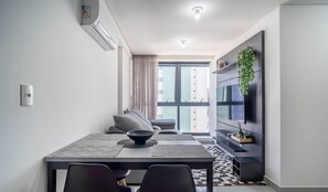 A modern dining area with a table, chairs, and a large window. - Comfort and Convenience Just 850m From Tambau Beach - Onws (João Pessoa)