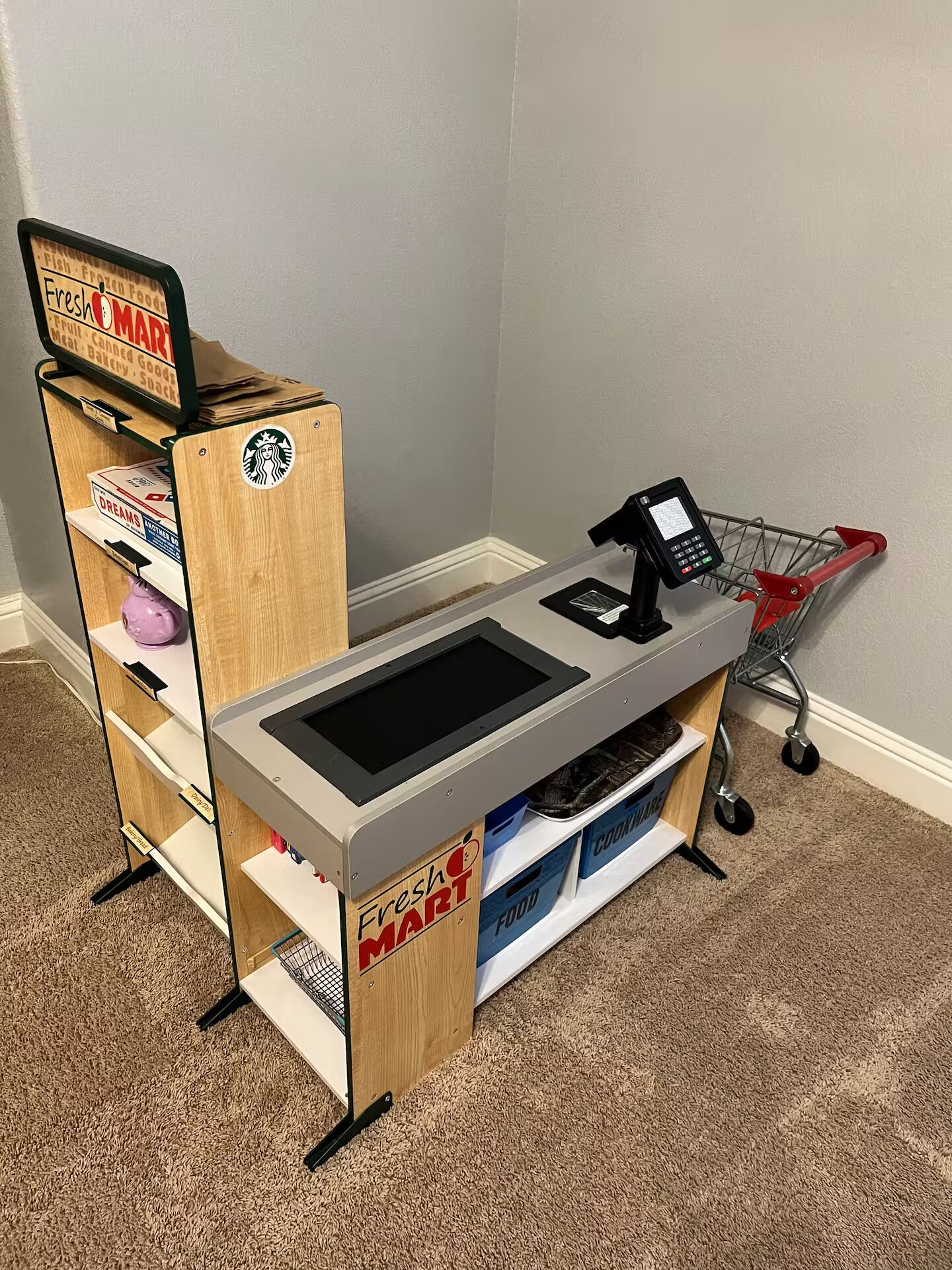 A Fresh Mart checkout counter with a self-service kiosk and a shopping cart.