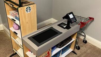 A Fresh Mart checkout counter with a self-service kiosk and a shopping cart.