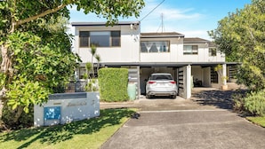A modern two-story house with a covered garage and a car parked inside. - Woodside on Brolga 3 Peregian Beach (PEREGIAN BEACH)