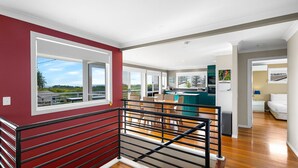 A modern interior with a dining area, kitchen, and bedroom. - Brolga Place Noosa Shire (PEREGIAN BEACH)