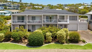 A two-story residential building with a balcony on the second floor, surrounded by well-maintained landscaping. - Blairgowrie 5 Peregian Beach (PEREGIAN BEACH)