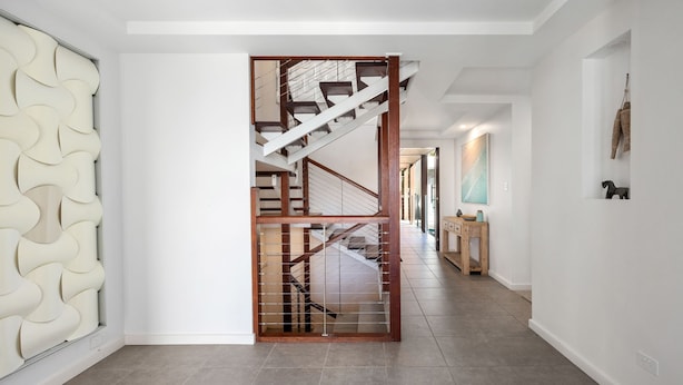A modern interior with a staircase, white walls, and a tiled floor. - Sea Splash Peregian Beach (PEREGIAN BEACH)