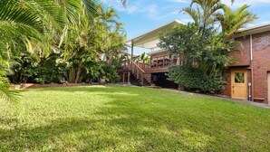 A residential property with a covered outdoor area, a brick building, and lush greenery. - Gannet's Nest Peregian Beach (Peregian Beach)