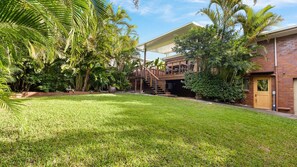 A residential property with a covered outdoor area, a brick building, and lush greenery. - Gannet's Nest Peregian Beach (Peregian Beach)