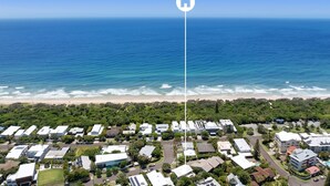 An aerial view of a coastal residential area with houses, a beach, and the ocean. - Sunbright 1 Peregian Beach (Peregian Beach)