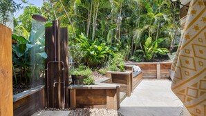A wooden deck with a built-in bench and a small planter. - Sunbright 1 Peregian Beach (Peregian Beach)