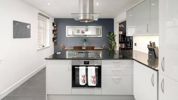 A modern kitchen with a stainless steel range hood, a built-in oven, and white cabinetry. - Stylish 2-Bed Flat with Balcony Near Haymarket - Pass the Keys (Edinburgh)