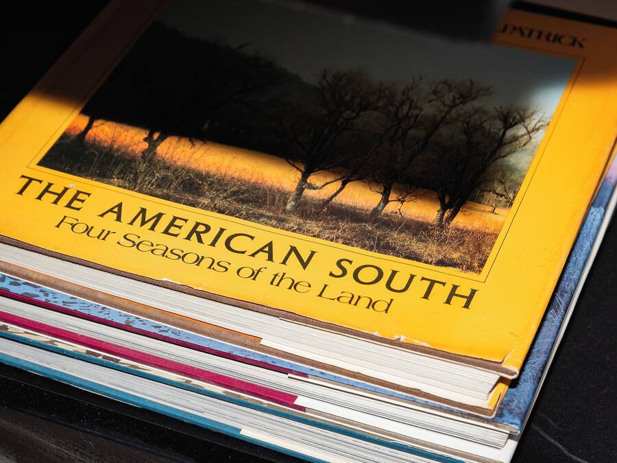A stack of books titled "The American South: Four Seasons of the Land."