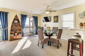 A dining area with a table, chairs, and a ceiling fan. - Steps to Pool & Beach: Coastal Carolina Condo! (Surfside Beach)