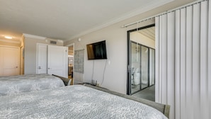 A bedroom with two beds, a TV, a sliding glass door, and a view of a balcony. - 2 Mi to Tigertail Beach! Resort-Style Gem w/ Pool (Marco Island)