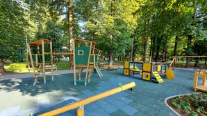 A playground with various play structures, including a climbing frame and a seesaw, surrounded by trees. - Nice apartment in Delnice with WiFi (Delnice)