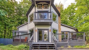 A two-story house with a balcony, a front door, and a number 1463 on the front. - 2BR/2BA, 2 Fireplaces, Hot Tub, 10 Minutes from Downtown and GSMNP, No Pet Fee! (Gatlinburg)