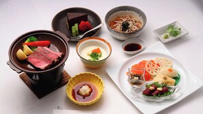 A variety of dishes including a pot of beef, a bowl of soup, and a plate with sashimi. - Chateraise Lodge Vintage (Hokuto)