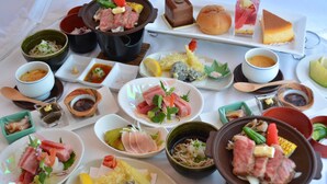 Verschiedene Gerichte, darunter Sushi, Sashimi und eine Suppentopf.