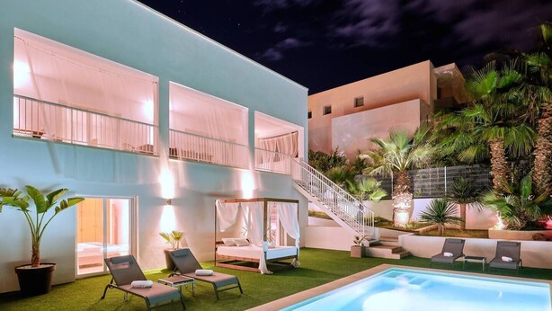 A modern villa with a pool, a covered outdoor seating area, and a staircase leading to a balcony. - Villa Julieta – Ibiza Town (2 min) (Nuestra Señora De Jesus)