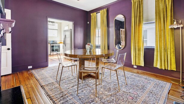A dining area with a round table, chairs, and a ceiling fan. - Colorful House w. Outdoor Space + Parking (Charleston)
