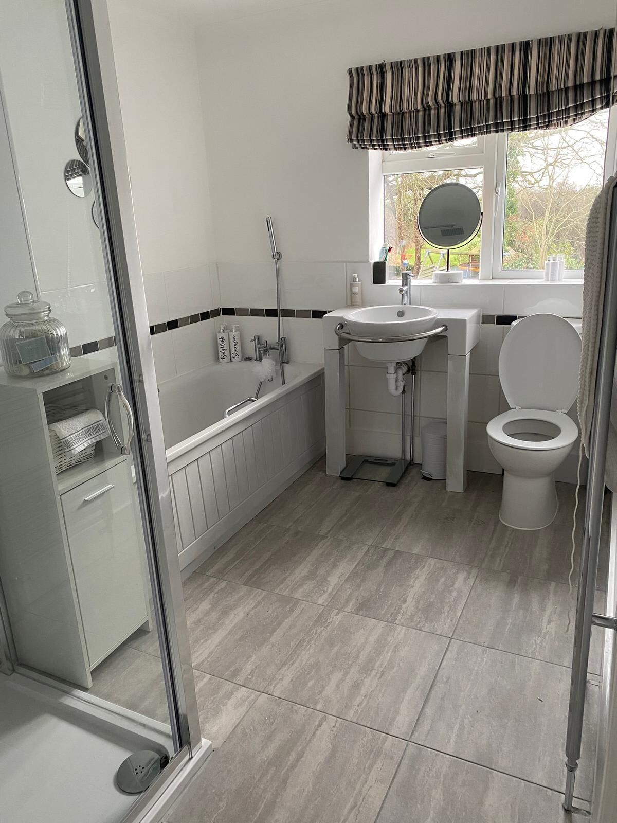 A bathroom with a bathtub, a sink, a toilet, and a shower.