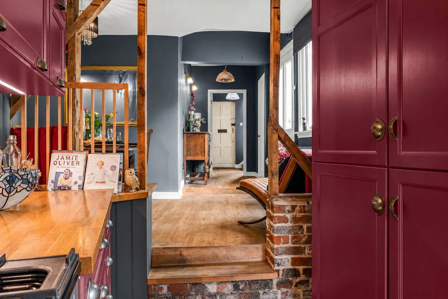 Kitchen Views: Rich burgundy cabinetry flows through this characterful home!