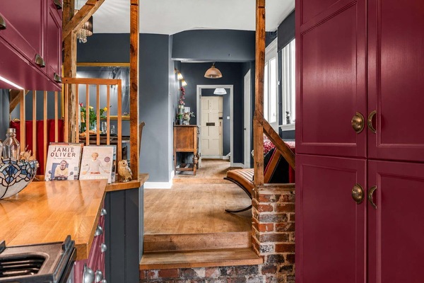 Kitchen Views: Rich burgundy cabinetry flows through this characterful home!