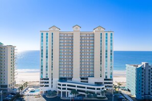 A high-rise hotel with multiple floors, a swimming pool, and a beach view. - Crystal Shores West Beachfront 2 Bed. Indoor/Outdoor Pool. Free Daily Activities (Gulf Shores)