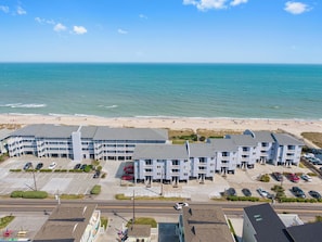 A coastal hotel with multiple floors, a parking lot, and a beach view. - Sea Colony #35b - Sunrise Balcony (Carolina Beach)