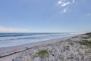 A beach with a sandy shore and ocean waves. - Luxury Oceanfront Condo in Prestigious Sawgrass (Ponte Vedra Beach)