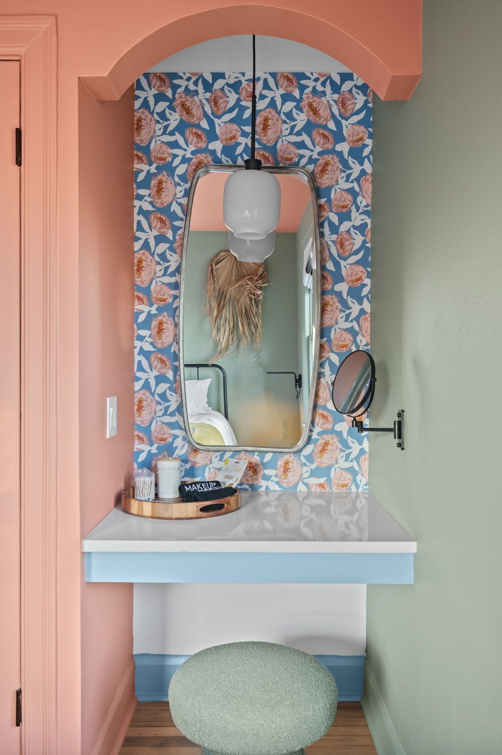 A bathroom with a mirror, a sink, and a vanity.