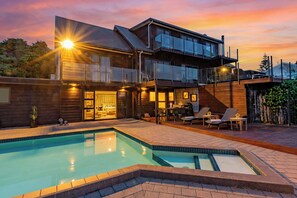 A modern two-story house with a swimming pool, outdoor seating, and a balcony. - HILLSIDE HAVEN (Whanganui)