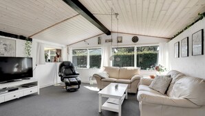 A modern living room with a TV, leather chair, and two sofas. - Stunning home in Sydals with WiFi (Sydals)