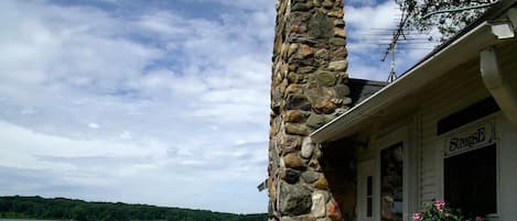 A stone pillar, a building with a 'Sunrise' sign, and a view of a lake.